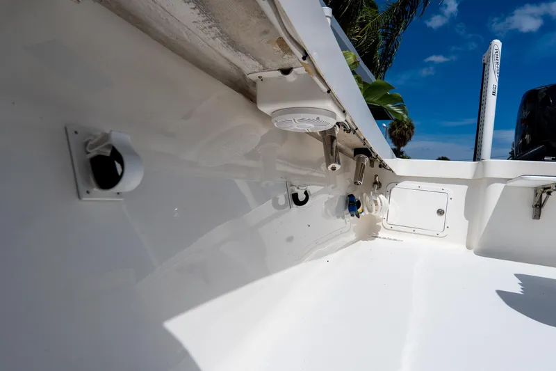 Slide: The Image of Interior view of a 2022 Croswait 21 boat, showcasing sleek white design and equipment. - 30