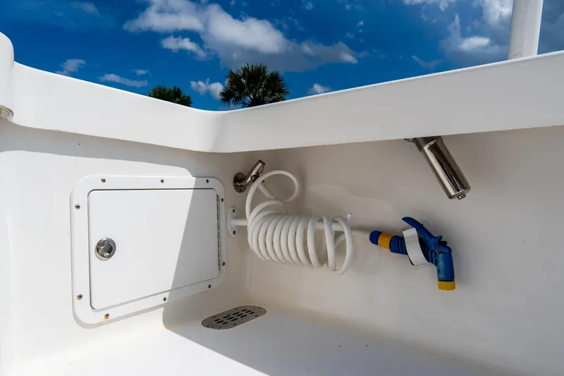 Slide: The Image of Croswait 21 boat interior detail, featuring hose and storage compartment, 2022 model. - 32