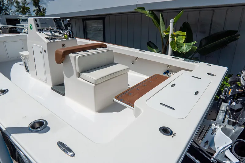 Slide: The Image of 2022 Croswait 21 boat interior with seating, control panel, and storage compartments. - 8