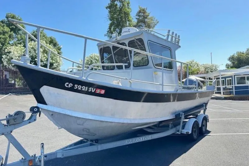 Slide: The Image of 1998 Fishing model 22 boat on trailer in parking lot, sunny day. - 8