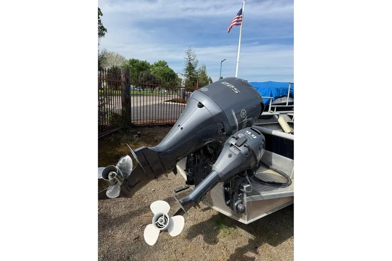Slide: The Image of Dual outboard motors on a fishing boat, model 22, year 1998, with American flag. - 9