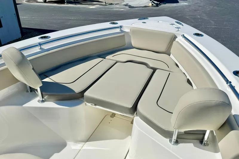 Slide: The Image of 2026 Key West 239 FS boat interior with cushioned seating and sleek design. - 11