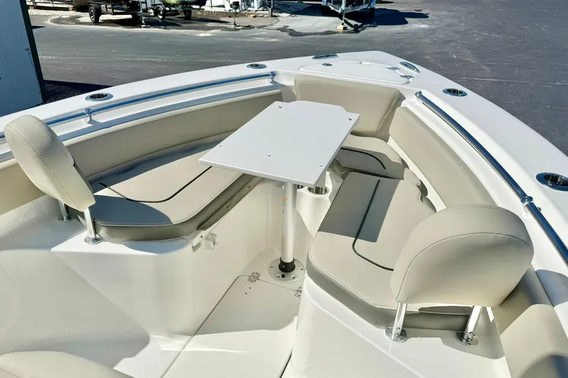 Slide: The Image of 2026 Key West 239 FS boat interior with seating and table setup. - 12
