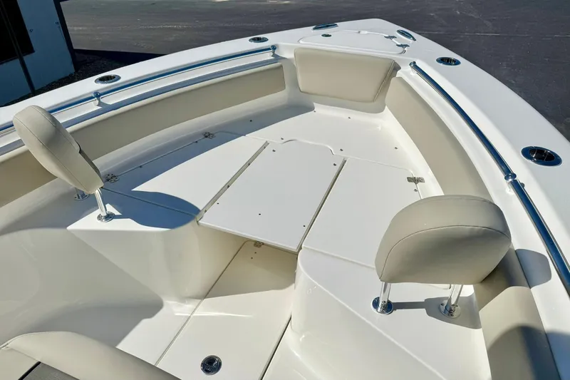 Slide: The Image of 2026 Key West 239 FS boat interior with cushioned seating and table. - 13