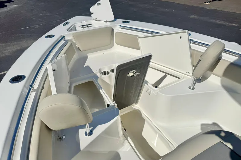 Slide: The Image of 2026 Key West 239 FS boat interior with open storage compartments and seating. - 14