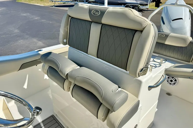 Slide: The Image of 2026 Key West 239 FS boat interior with cushioned seating and steering wheel. - 21