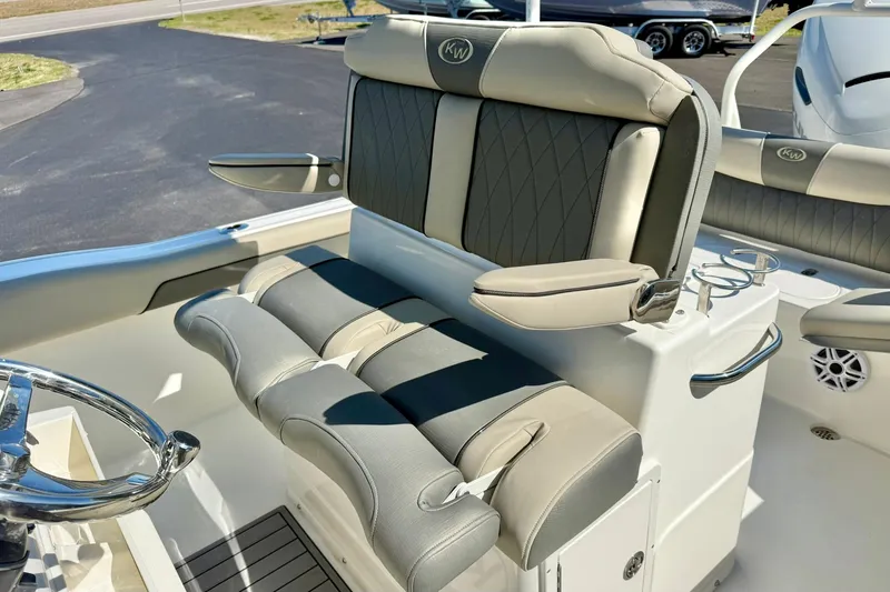 Slide: The Image of 2026 Key West 239 FS boat interior with cushioned seating and steering wheel. - 22
