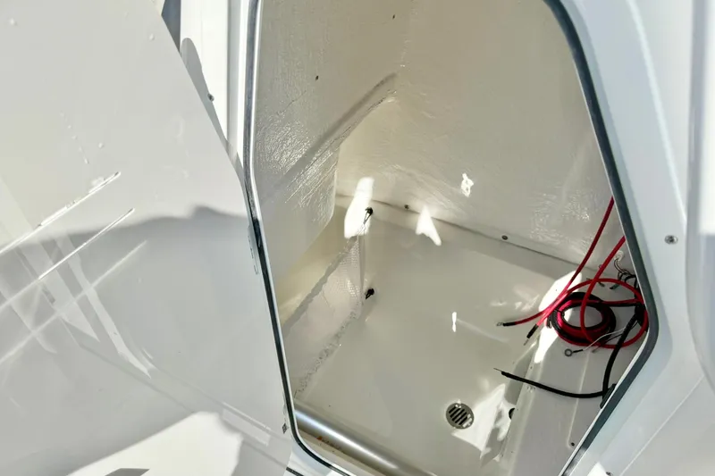 Slide: The Image of Interior compartment of 2026 Key West 239 FS boat, featuring storage space and wiring. - 24