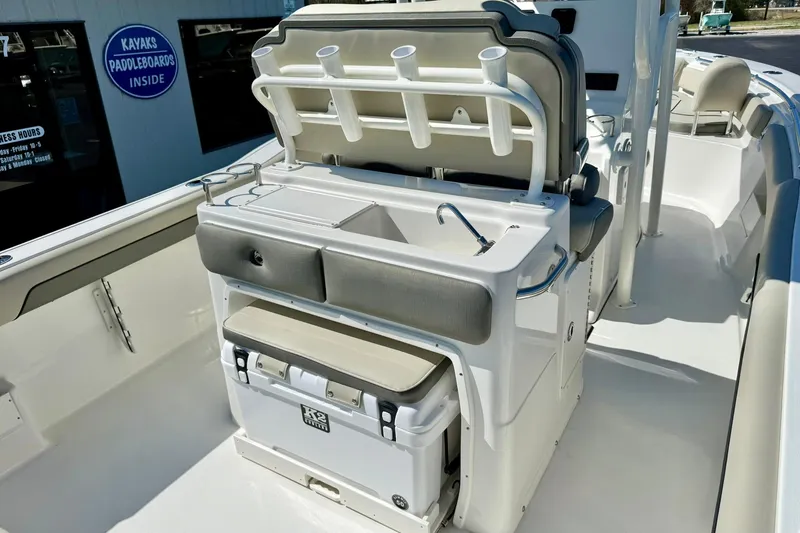 Slide: The Image of 2026 Key West 239 FS boat interior with seating, rod holders, and storage. - 25