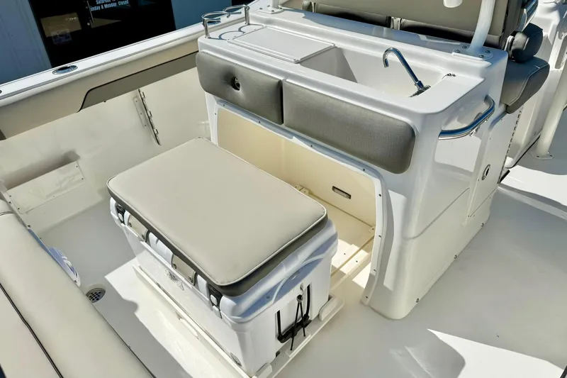 Slide: The Image of 2026 Key West 239 FS boat interior with seating and sink area. - 26