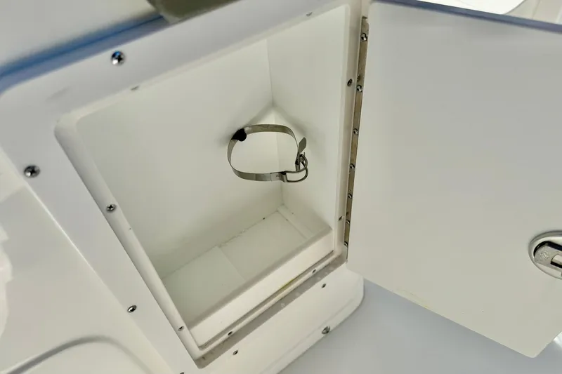 Slide: The Image of Open storage compartment on 2026 Key West 239 FS boat, featuring a secure latch. - 29