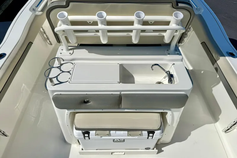 Slide: The Image of 2026 Key West 239 FS boat interior with rod holders, sink, and storage. - 31