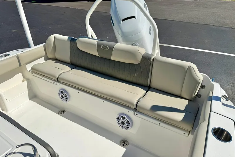 Slide: The Image of 2026 Key West 239 FS boat interior with beige cushioned seating and built-in speakers. - 32