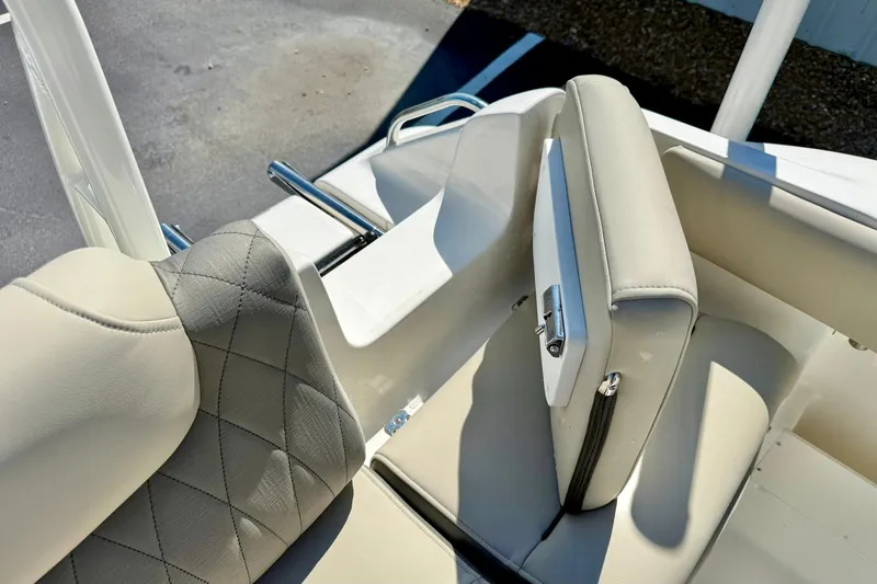 Slide: The Image of 2026 Key West 239 FS boat seating with beige upholstery and stainless steel accents. - 33