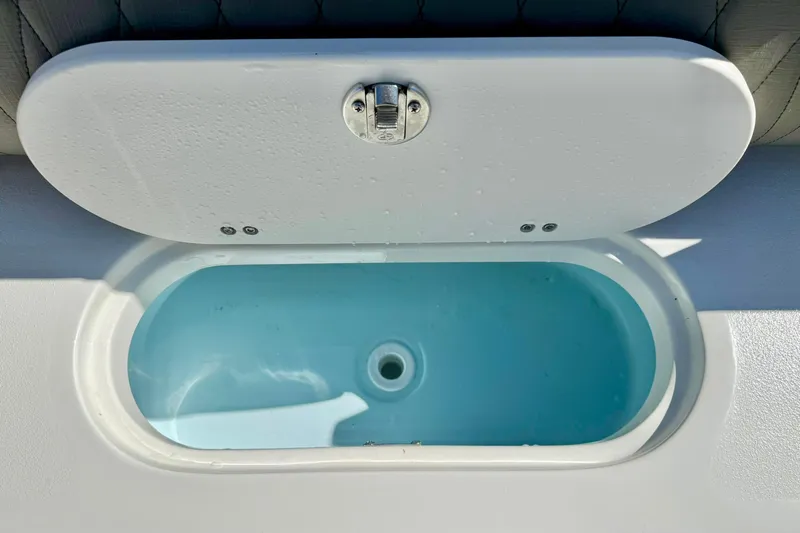 Slide: The Image of Livewell compartment on a 2026 Key West 239 FS boat, open lid view. - 37