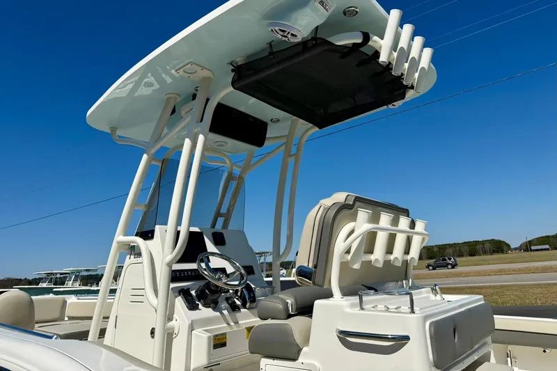 Slide: The Image of 2026 Key West 239 FS boat console with T-top and rod holders under clear blue sky. - 42