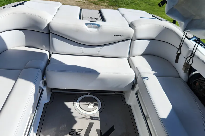 Slide: The Image of 2019 MasterCraft XT22 boat interior with white seating and modern design. - 2