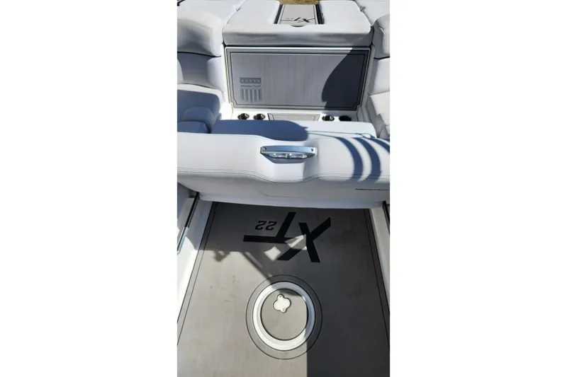 Slide: The Image of 2019 MasterCraft XT22 boat interior with seating and storage area. - 3