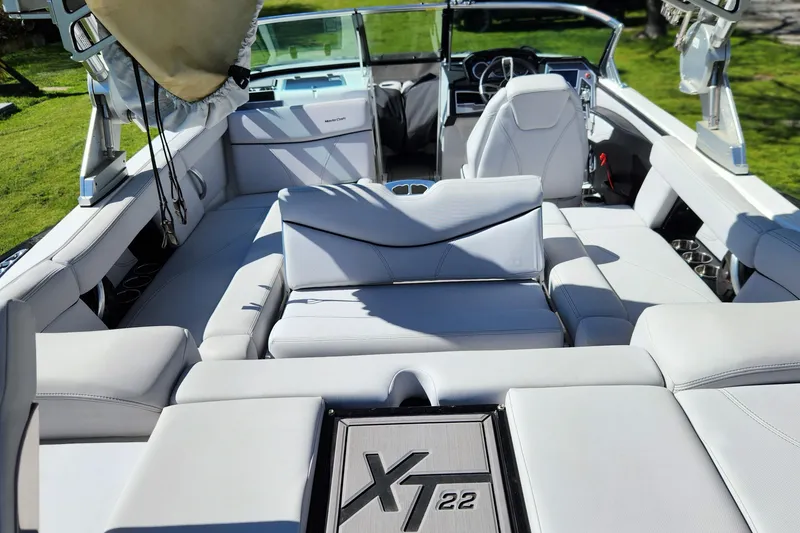 Slide: The Image of 2019 MasterCraft XT22 boat interior with luxurious seating and modern dashboard. - 7