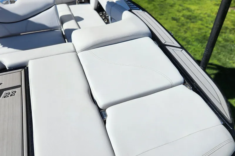 Slide: The Image of 2019 MasterCraft XT22 boat with sleek white seating and modern design. - 8