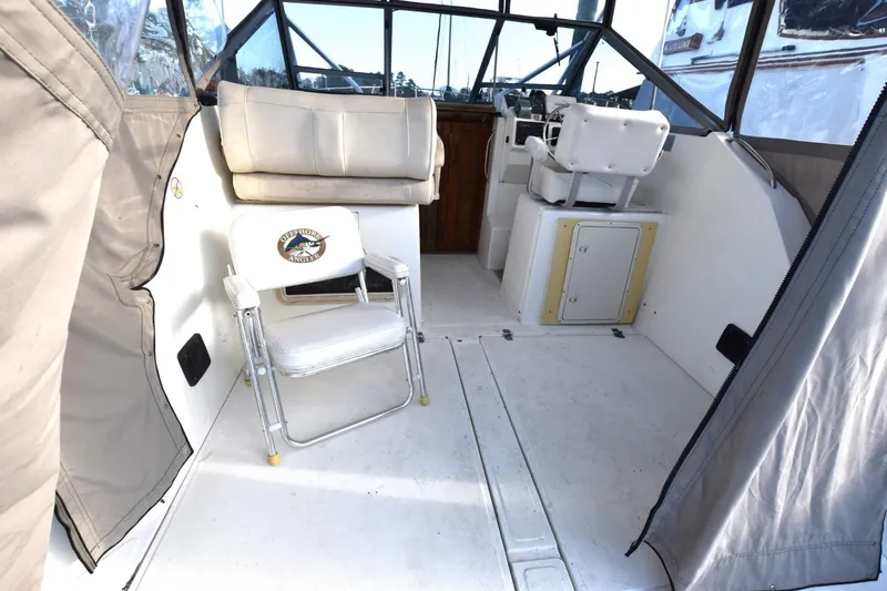 Slide: The Image of 1987 Luhrs Alura 35 boat interior with seating and helm, featuring a clean, spacious design. - 12