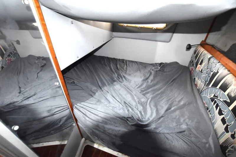 Slide: The Image of Cozy cabin interior of 1987 Luhrs Alura 35 with gray bedding and floral upholstery. - 22