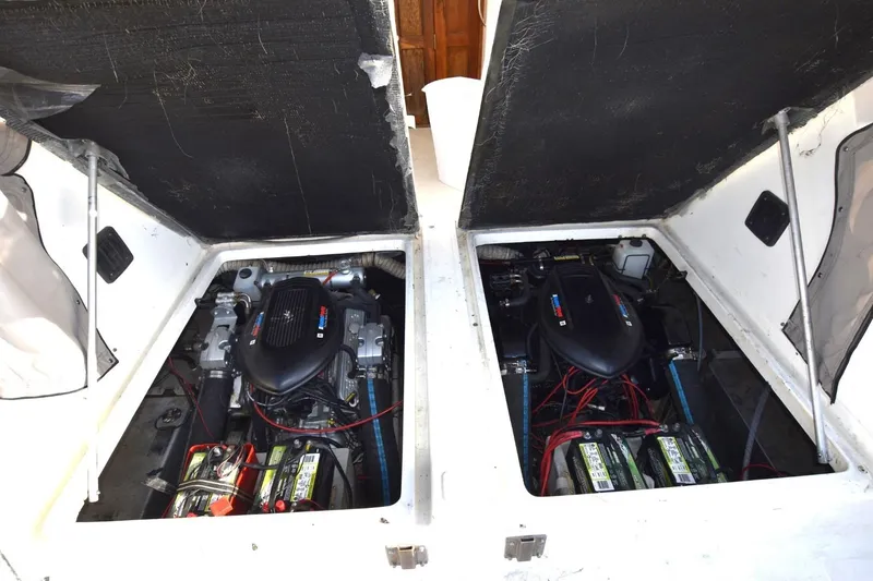 Slide: The Image of Engine compartment of a 1987 Luhrs Alura 35 boat, featuring dual engines and batteries. - 23