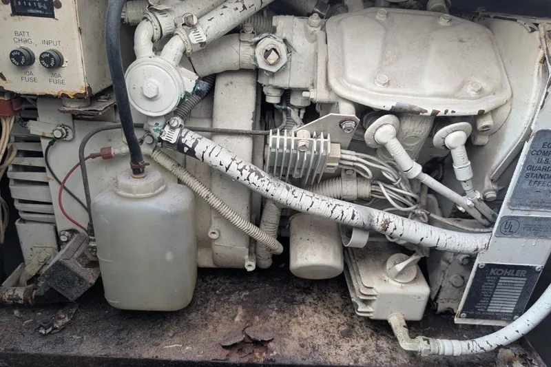 Slide: The Image of Engine compartment of a 1987 Luhrs Alura 35 boat, showing mechanical components and wiring. - 26