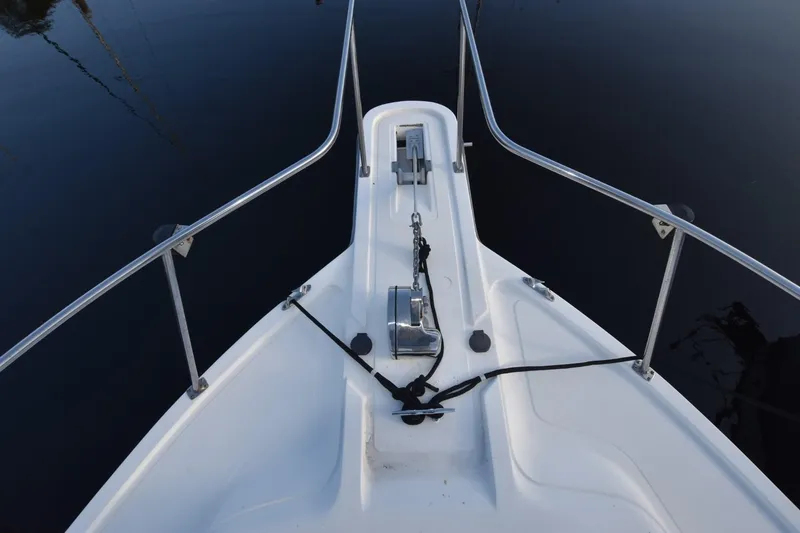 Slide: The Image of Bow of 1987 Luhrs Alura 35 boat with anchor and railings on calm water. - 5