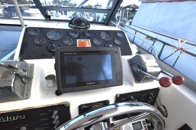 Slide: The Image of 1987 Luhrs Alura 35 boat dashboard with Garmin GPS and control panel. - 8