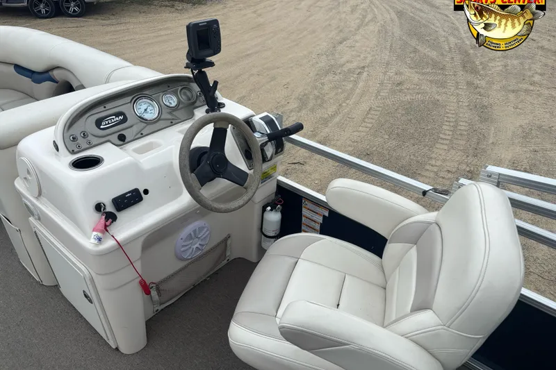 Slide: The Image of 2012 Sylvan 820 Mirage Cruise boat interior with steering wheel and dashboard controls. - 5