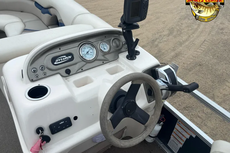 Slide: The Image of 2012 Sylvan 820 Mirage Cruise boat dashboard with steering wheel and controls. - 6