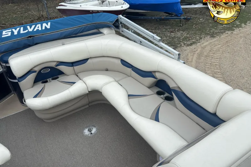 Slide: The Image of 2012 Sylvan 820 Mirage Cruise boat with plush seating and cup holders. - 8