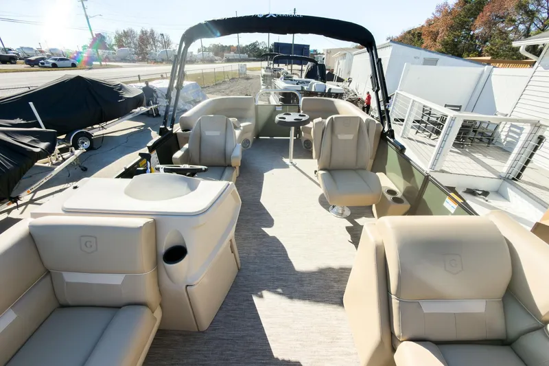 Slide: The Image of 2026 Godfrey Sweetwater Xperience 22' Tritoon with split bench seating, docked outdoors. - 13