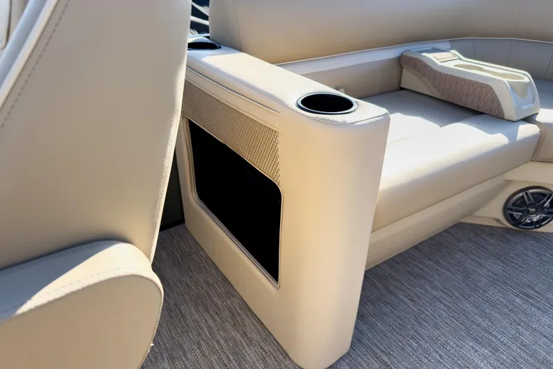 Slide: The Image of 2026 Godfrey Sweetwater Xperience 22' Tritoon interior with beige seating and cup holders. - 23