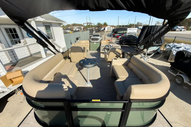 Slide: The Image of 2026 Godfrey Sweetwater Xperience 22' Tritoon with split bench seating, docked outdoors. - 25