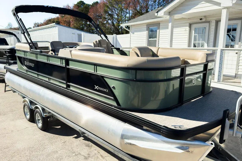 Slide: The Image of 2026 Godfrey Sweetwater Xperience 22' Split Bench Tritoon, parked on a trailer, side view. - 4