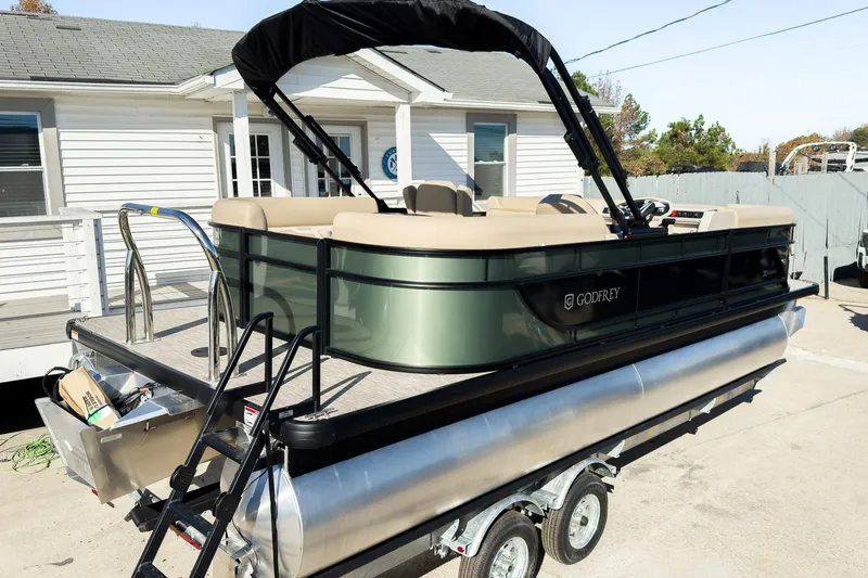 Slide: The Image of 2026 Godfrey Sweetwater Xperience 22' Tritoon with split bench, parked on trailer. - 5
