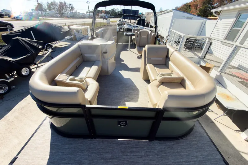 Slide: The Image of 2026 Godfrey Sweetwater Xperience 22' Tritoon with split bench seating, docked outdoors. - 8