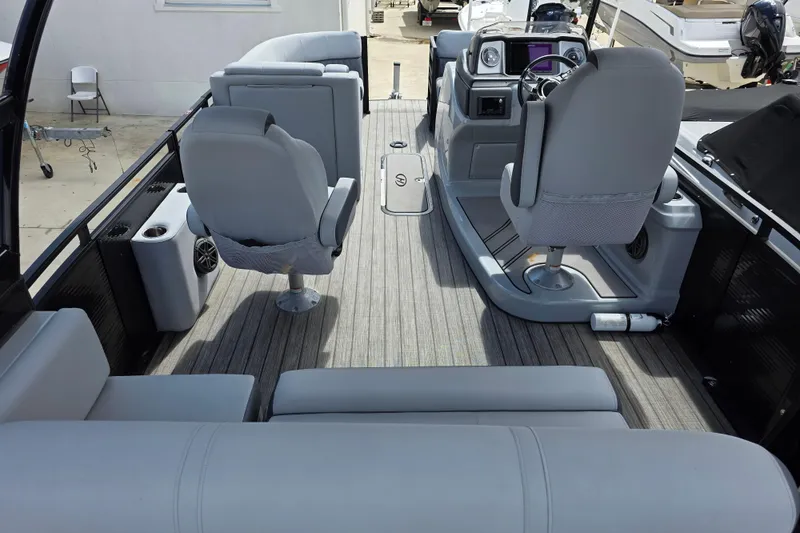Slide: The Image of 2021 Harris Solstice 230 SL boat interior with modern seating and steering console. - 11