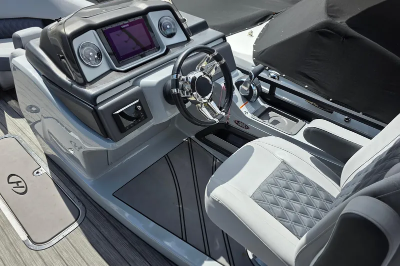 Slide: The Image of 2021 Harris Solstice 230 SL boat dashboard with modern steering and control panel. - 15