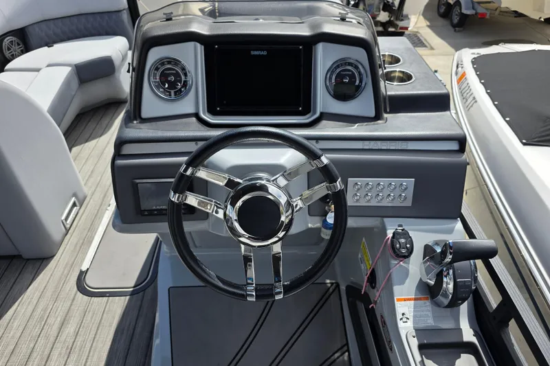Slide: The Image of 2021 Harris Solstice 230 SL boat dashboard with steering wheel and control panel. - 16