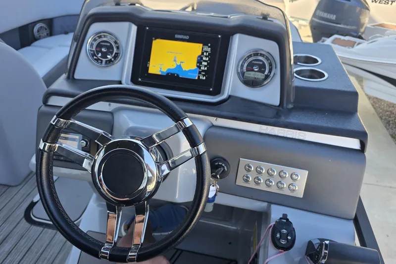 Slide: The Image of Steering console of 2021 Harris Solstice 230 SL boat with navigation display and controls. - 17