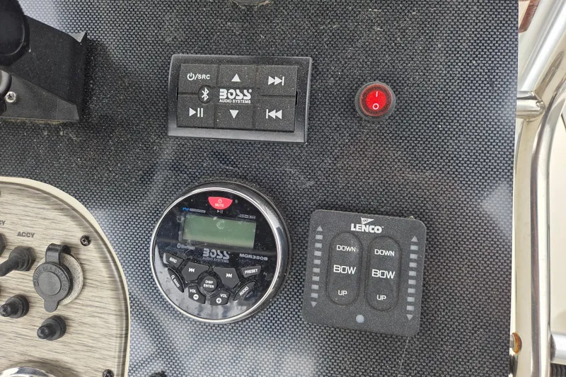 Slide: The Image of Control panel of a 2014 Carolina Skiff Sea Skiff 21 CC with audio and trim controls. - 10