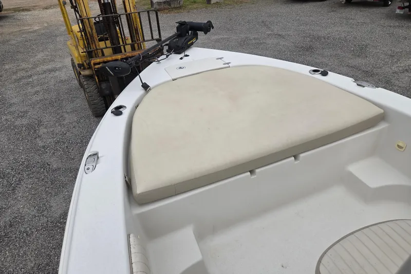 Slide: The Image of 2014 Carolina Skiff Sea Skiff 21 CC boat with cushioned bow, parked on gravel. - 16