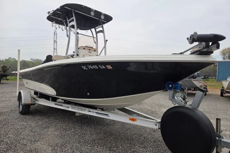 Slide: The Image of 2014 Carolina Skiff Sea Skiff 21 CC boat on trailer, black hull, outdoor setting. - 2