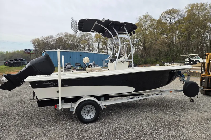 Slide: The Image of 2014 Carolina Skiff Sea Skiff 21 CC boat on trailer, parked outdoors. - 3