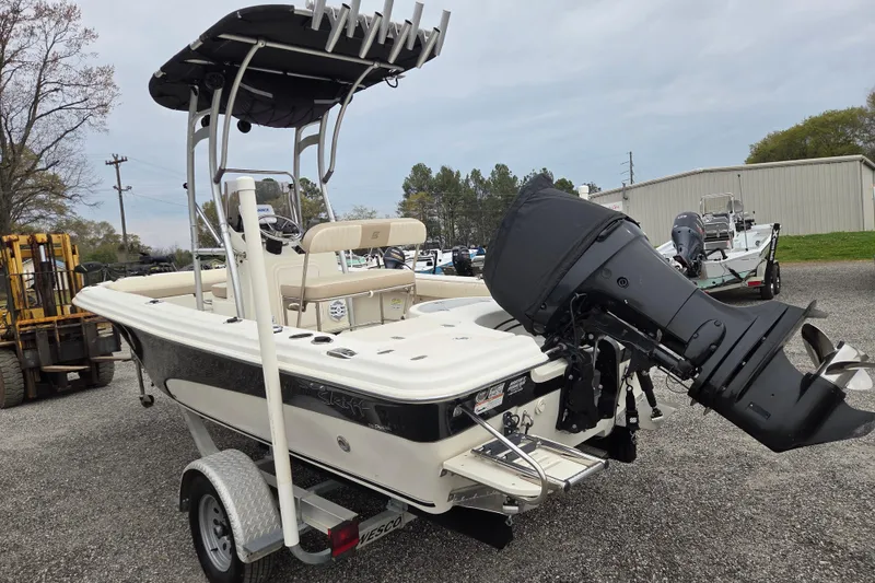 Slide: The Image of 2014 Carolina Skiff Sea Skiff 21 CC boat on trailer, featuring outboard motor. - 5