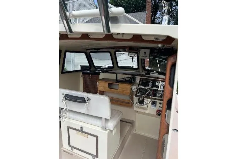 Slide: The Image of 1998 General Marine Custom Downeast boat interior with steering wheel and seating area. - 10