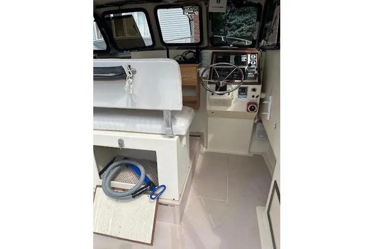 Slide: The Image of 1998 General Marine Custom Downeast boat interior with steering wheel and seating area. - 11